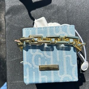 White and Baby Blue Scrunch Bag with chain on the inside.